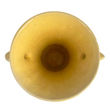 Load image into Gallery viewer, Exceptionally beautiful vintage gloss yellow art deco vase, features a melon base flowing into a trumpet shape finished with leaf topped handles. Crafted by McCoy Pottery, 1948. This rare vase must for any art pottery collector!

In as found vintage condition, no chips//repairs. There is a tight hairline crack on one of the handles and age-related crazing commensurate. Maker&#39;s mark on the bottom.

Measures 7 x 9 1/8 inches
