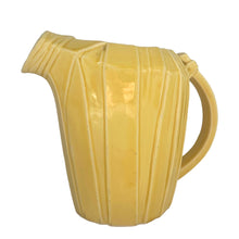 Load image into Gallery viewer, Exceptional vintage gloss yellow art deco leaf wrapped pitcher with strap handle. Crafted by McCoy Pottery, 1949. This rare pitcher must for any art pottery collector!

In excellent vintage condition, no chips/crack/repairs, no noticeable crazing. Maker&#39;s mark on the bottom.

Measures 8 x 5 x 7 3/4 inches (incl. handle)

Capacity 55 ounces
