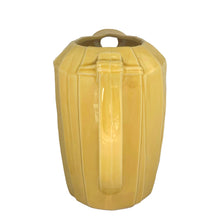 Load image into Gallery viewer, Exceptional vintage gloss yellow art deco leaf wrapped pitcher with strap handle. Crafted by McCoy Pottery, 1949. This rare pitcher must for any art pottery collector!

In excellent vintage condition, no chips/crack/repairs, no noticeable crazing. Maker&#39;s mark on the bottom.

Measures 8 x 5 x 7 3/4 inches (incl. handle)

Capacity 55 ounces
