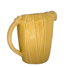 Load image into Gallery viewer, Exceptional vintage gloss yellow art deco leaf wrapped pitcher with strap handle. Crafted by McCoy Pottery, 1949. This rare pitcher must for any art pottery collector!

In excellent vintage condition, no chips/crack/repairs, no noticeable crazing. Maker&#39;s mark on the bottom.

Measures 8 x 5 x 7 3/4 inches (incl. handle)

Capacity 55 ounces
