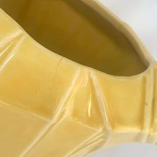 Load image into Gallery viewer, Exceptional vintage gloss yellow art deco leaf wrapped pitcher with strap handle. Crafted by McCoy Pottery, 1949. This rare pitcher must for any art pottery collector!

In excellent vintage condition, no chips/crack/repairs, no noticeable crazing. Maker&#39;s mark on the bottom.

Measures 8 x 5 x 7 3/4 inches (incl. handle)

Capacity 55 ounces
