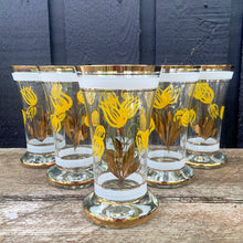 Load image into Gallery viewer, Vintage blown glass lemonade pitcher and glasses set hand painted with yellow flowers with gold leaves, white and gold bands and rims. Crafted in Romania, 1950s. A lovely set to add cheer to your table.

In excellent condition, no chips. Original stickers marked, Made in Roumania.

Pitcher measures 8 1/2 x 11 inches. Capacity 80 ounces

Glasses measure 3 1/2 x 5 7/8 inches. Capacity 16 ounces
