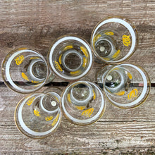 Load image into Gallery viewer, Vintage blown glass lemonade pitcher and glasses set hand painted with yellow flowers with gold leaves, white and gold bands and rims. Crafted in Romania, 1950s. A lovely set to add cheer to your table.

In excellent condition, no chips. Original stickers marked, Made in Roumania.

Pitcher measures 8 1/2 x 11 inches. Capacity 80 ounces

Glasses measure 3 1/2 x 5 7/8 inches. Capacity 16 ounces
