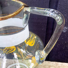 Load image into Gallery viewer, Vintage blown glass lemonade pitcher and glasses set hand painted with yellow flowers with gold leaves, white and gold bands and rims. Crafted in Romania, 1950s. A lovely set to add cheer to your table.

In excellent condition, no chips. Original stickers marked, Made in Roumania.

Pitcher measures 8 1/2 x 11 inches. Capacity 80 ounces

Glasses measure 3 1/2 x 5 7/8 inches. Capacity 16 ounces

