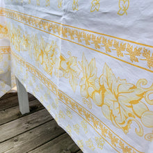 Load image into Gallery viewer, We are suckers for gorgeous linens and this piece does not disappoint! This large cotton tablecloth features a pattern of grapes and vines in shades of yellow. Made in Italy of 100% cotton. A lovely dress for your table!  This piece is new old stock and does not appear to have been used to laundered and is in excellent condition.   Measures 58 x 90 inches
