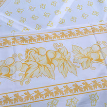 Load image into Gallery viewer, We are suckers for gorgeous linens and this piece does not disappoint! This large cotton tablecloth features a pattern of grapes and vines in shades of yellow. Made in Italy of 100% cotton. A lovely dress for your table!  This piece is new old stock and does not appear to have been used to laundered and is in excellent condition.   Measures 58 x 90 inches
