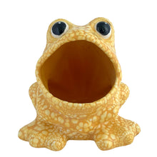 Load image into Gallery viewer, Front view of vintage yellow lava glaze ceramic frog sponge holder, showing the deep hollow interior of the open mouth, bulging black eyes, and pebbled lava glaze across the full body
