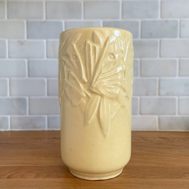Vintage Art Deco matte yellow Butterfly Line cylinder vase. Crafted by Nelson McCoy Pottery, early 1940s. This rare piece is must for any art pottery collector! A lovely way to enhance your home's decor or give as a gift!

In good vintage condition, no chips/cracks/repairs. Heavy age-related crazing, manufacturer's glaze pops. Maker's marks.

Measures 4 3/8 x 8 1/8 inches
