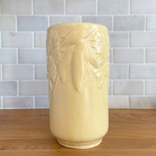 Load image into Gallery viewer, Vintage Art Deco matte yellow Butterfly Line cylinder vase. Crafted by Nelson McCoy Pottery, early 1940s. This rare piece is must for any art pottery collector! A lovely way to enhance your home&#39;s decor or give as a gift!

In good vintage condition, no chips/cracks/repairs. Heavy age-related crazing, manufacturer&#39;s glaze pops. Maker&#39;s marks.

Measures 4 3/8 x 8 1/8 inches
