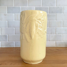 Load image into Gallery viewer, Vintage Art Deco matte yellow Butterfly Line cylinder vase. Crafted by Nelson McCoy Pottery, early 1940s. This rare piece is must for any art pottery collector! A lovely way to enhance your home&#39;s decor or give as a gift!

In good vintage condition, no chips/cracks/repairs. Heavy age-related crazing, manufacturer&#39;s glaze pops. Maker&#39;s marks.

Measures 4 3/8 x 8 1/8 inches
