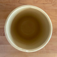 Load image into Gallery viewer, Vintage Art Deco matte yellow Butterfly Line cylinder vase. Crafted by Nelson McCoy Pottery, early 1940s. This rare piece is must for any art pottery collector! A lovely way to enhance your home&#39;s decor or give as a gift!

In good vintage condition, no chips/cracks/repairs. Heavy age-related crazing, manufacturer&#39;s glaze pops. Maker&#39;s marks.

Measures 4 3/8 x 8 1/8 inches
