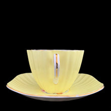 Load image into Gallery viewer, Handle profile of vintage EB Foley 1850 scalloped bone china teacup, yellow with floral motif and gold gilt
