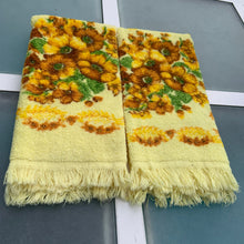 Load image into Gallery viewer, Pair of vibrant vintage yellow 100% cotton terry cloth hand towels featuring a floral pattern in yellow, ochre, brown and green finished with fringed edges. Crafted by Wabasso, Canada, circa 1970s. Deck out your home or cottage bath with the fabulous towels!  In excellent, like-new condition, free from tears/stains.  Measures 14 1/2 x 23 1/2 inches cottagecore retro
