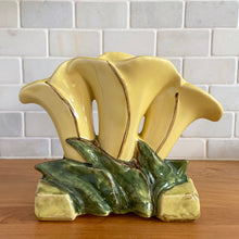 Load image into Gallery viewer, Rare vintage mid-century yellow triple lily vase. Crafted by McCoy Pottery, USA, 1950s. This rare piece is must for any art pottery collector!

In excellent condition, no chips/cracks/repairs. Maker's mark.

Measures 8 1/8 x 3 1/2 x 6 3/4 inches
