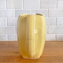 Load image into Gallery viewer, Charming vintage sunny yellow tulip pitcher. Crafted by McCoy Pottery, 1940s. This collectible pitcher is the perfect vessels to hold a charming bouquet of spring flowers or a lovely gift for an art pottery collector.

In as found vintage condition, chip to the rim and handle, tight horizontal hairline crack on handle, age-related crazing, manufacturer&#39;s glaze pops. Maker&#39;s mark.

Measures 8 1/4 x 3 1/2 x 6 inches
