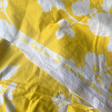 Load image into Gallery viewer, A stunning crisp yellow and white floral printed cotton fabric from The Flower  Show Collection in the &quot;Spring Rambler&quot; pattern of white florals against vibrant yellow creating a silhouette effect. The yardage is hemmed at each end. Repurpose this gorgeous textile for sewing and craft projects  Free from stains/tears. Marked along the selvedge &quot;Spring Rambler from the Flower Show Collection © by Greeff. Printed in England for Warner &amp; Sons Limited.  Measures 100 x 52 inches (8.33 yards)
