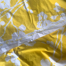 Load image into Gallery viewer, A stunning crisp yellow and white floral printed cotton fabric from The Flower  Show Collection in the &quot;Spring Rambler&quot; pattern of white florals against vibrant yellow creating a silhouette effect. The yardage is hemmed at each end. Repurpose this gorgeous textile for sewing and craft projects  Free from stains/tears. Marked along the selvedge &quot;Spring Rambler from the Flower Show Collection © by Greeff. Printed in England for Warner &amp; Sons Limited.  Measures 100 x 52 inches (8.33 yards)
