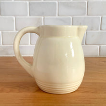 Load image into Gallery viewer, Antique vintage art deco ceramic creamer pitcher 1504 featuring an impressed yellow window or thistle on pale yellow ground. Crafted by Robinson Ransbottom Pottery Co., USA, 1920s. A unique piece to add to your art pottery tableware collection!

In excellent condition, no chips/cracks/repairs, normal age-related crazing. Maker&#39;s marks.

Measures 4 1/2 x 3 1/4 x 4 1/4 inches

