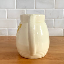 Load image into Gallery viewer, Antique vintage art deco ceramic creamer pitcher 1504 featuring an impressed yellow window or thistle on pale yellow ground. Crafted by Robinson Ransbottom Pottery Co., USA, 1920s. A unique piece to add to your art pottery tableware collection!

In excellent condition, no chips/cracks/repairs, normal age-related crazing. Maker&#39;s marks.

Measures 4 1/2 x 3 1/4 x 4 1/4 inches
