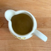 Load image into Gallery viewer, Antique vintage art deco ceramic creamer pitcher 1504 featuring an impressed yellow window or thistle on pale yellow ground. Crafted by Robinson Ransbottom Pottery Co., USA, 1920s. A unique piece to add to your art pottery tableware collection!

In excellent condition, no chips/cracks/repairs, normal age-related crazing. Maker&#39;s marks.

Measures 4 1/2 x 3 1/4 x 4 1/4 inches
