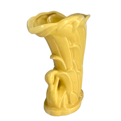 Beautiful vintage gloss yellow Swan vase, features a swan swimming in the reeds. Crafted by McCoy Pottery, 1948. This vase is must for any art pottery collector!

In as found vintage condition, roughness to the rim and minor tight hairline crack, age-related crazing. Maker's mark on the bottom.

Measures 6 7/8 x 4 1/4 x 9 3/8 inches