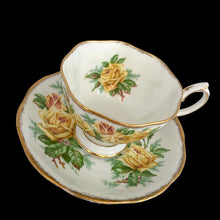 Load image into Gallery viewer, This vintage Tea Rose bone china teacup and saucer is so pretty! Both the Malvern shaped cup and saucer have a lovely scalloped edge with hand painted roses in shades of yellow and green with gold gilt rim. Crafted by Royal Albert, England, circa 1940s. A lovely addition to your teacup collection or to give as a gift!

In excellent condition, free from chips, cracks and repairs. Makers marks present.

Teacup measures 3 1/2 x 2 3/4 inches. Saucer measures 5 5/8 inches
