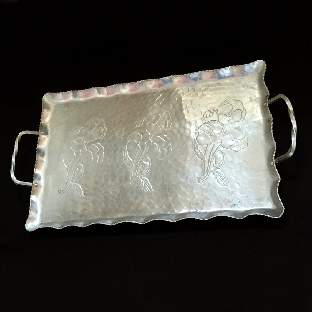 Vintage mid-century hand wrought hammered aluminum handled tray in the 