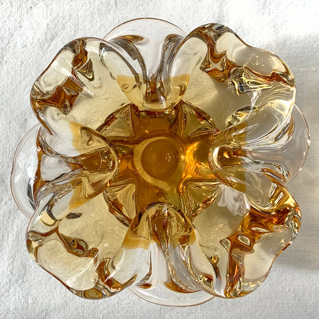 This vintage art glass ashtray is a rare find. Its four-sided yellow and clear design creates a beautiful flower-like bloom effect and is sure to be a standout addition to any vintage art glass collection as a stylish and functional piece.  In excellent condition, free from chips/cracks.  Measures 6 x 3 3/4 inches .