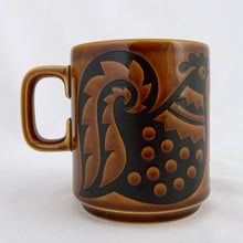 Load image into Gallery viewer, Perfect for your morning cuppa! This fabulous amber and brown vintage graphic mug was designed by John Clappison and produced by Hornsea in England, circa 1975. The  momma, daddy and baby chickens are decorated with dots, flowers and feathers....so sweet and highly collectible!  In excellent condition free from chips/cracks.  Measures 3 x 3-1/2 inches  Capacity 10 ounces
