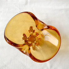 Load image into Gallery viewer, A stunning piece of amber art glass ashtray. Makes a beautiful addition to home decor. Use as trinket dish, catchall, candy dish or as originally intended. Made by Lorraine Glass, Canada, circa 1970.   In good vintage condition. A few minor flea bites at the base which are barely noticeable. The bottom is polished smooth.  Measures 6 3/4 x 4 x 4 inches
