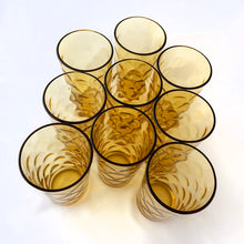 Load image into Gallery viewer, Vintage set of eight &quot;AHC111&quot; amber flat tumbler glass with a thumbprint/honeycomb pattern. Produced by the Anchor Hocking Glass Company, circa 1970.  In excellent used vintage condition, free from chips/cracks.  Measures 2 3/4 x 5 1/8 inches
