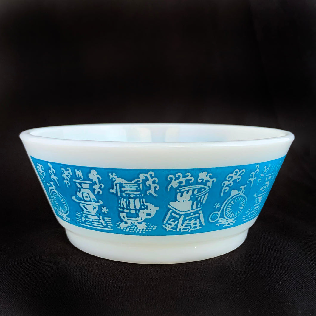 Vintage Fire-King milk glass blue banded cereal bowl with a design of antique housewares. Produced by Anchor Hocking, circa 1970. These printed cereal bowls are highly collectible.  In excellent condition, free from chips/cracks.  Measures 4 7/8 x 2 inches