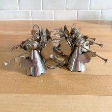 Load image into Gallery viewer, Set of six vintage silver trumpeting angel napkin rings. Made in Hong Kong and imported by Eaton&#39;s Canada, 1970s. Perfect for Christmas decorating, adding touch of vintage elegance to your holiday table decor!

In used vintage condition with great patina!

Each measures 2 3/4 x 1 1/4 x 2 3/8 inches
