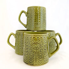 Load image into Gallery viewer, Graphic vintage mid-century era mug is glazed in avocado green and has a lovely impressed flower pattern. Produced by Noritake of Japan for Gift Craft Importers in Toronto, circa 1960s.  In excellent condition, free from chips/cracks.  Measures 3 1/8 x 3 1/2 inches
