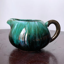 Load image into Gallery viewer, The pride of Collingwood, Ontario, Blue Mountain Pottery! This lovely 1960s vintage creamer would be a beautiful vessel for cream or repurpose as a planter for your favorite houseplant or succulent. As typical with BMP pottery, it is redware pottery finished with a drip glaze in deep greens and black. Unstamped bottom.  Excellent condition, no chips or cracks.  Size: 5.25&quot; x 2.75&quot;
