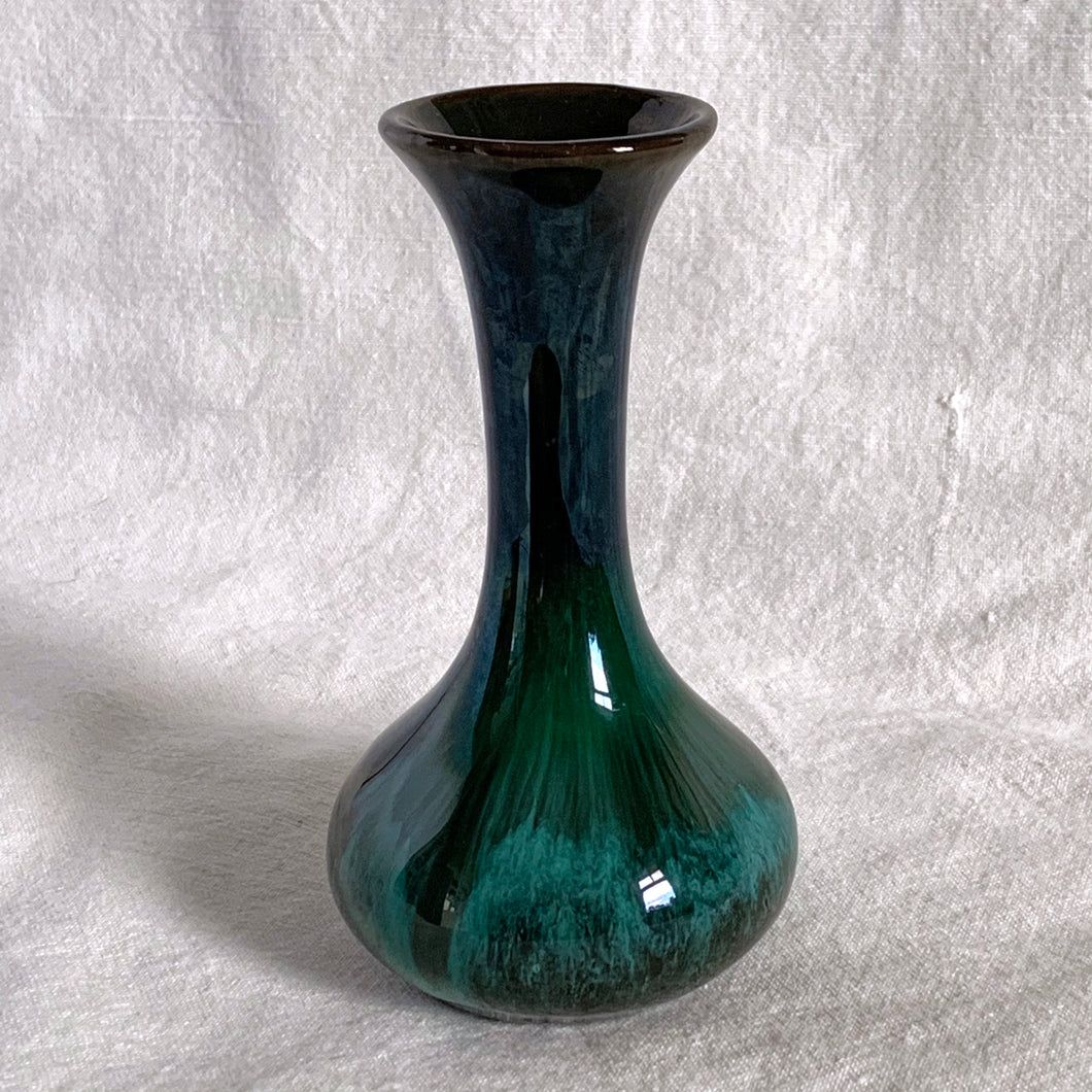 The pride of Collingwood, Ontario, Blue Mountain Pottery! This lovely bud vase will compliment and floral bouquet. Typical with BMP pottery, it has a drip glaze finish in deep greens and black.   Excellent condition, no chips or cracks.  Size: 3