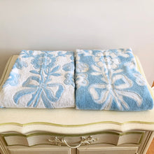 Load image into Gallery viewer, Vintage tone-on-tone blue and white bath towel with floral pattern and tied fringe edge.  In excellent condition, free form tears/stains.  Measures 28 1/2 x 54 inches
