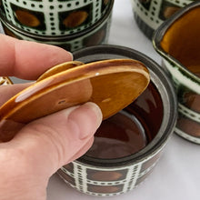 Load image into Gallery viewer, mid-century vintage  Bernadette coffee service. Includes coffee pot, creamer, covered sugar, six cups and saucers on the &quot;Delta&quot; shape. Boch Belgium, 1968.  hand painted in colours of deep green and brown on a white (off white) ground. In excellent used vintage condition. All pieces are free from chips/cracks/repairs with the exception of a minor chip to the sugar bowl lid and one saucer as shown in the photos.
