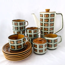 Load image into Gallery viewer, mid-century vintage  Bernadette coffee service. Includes coffee pot, creamer, covered sugar, six cups and saucers on the &quot;Delta&quot; shape. Boch Belgium, 1968.  hand painted in colours of deep green and brown on a white (off white) ground. In excellent used vintage condition. All pieces are free from chips/cracks/repairs with the exception of a minor chip to the sugar bowl lid and one saucer as shown in the photos.
