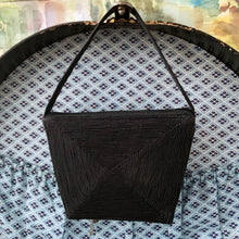 Load image into Gallery viewer, Gorgeous handmade art deco style 1940s vintage black corded evening bag with matching strap and push button closure. The interior is lined with black fabric with a small change purse. The bag is large enough for a small cell phone, credit cards/cash, compact/lipstick. Designed by Jo-Ann Original, made in Canada. A great period piece that would make an fabulous accessory. In overall excellent condition.
