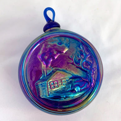 Vintage iridescent blue carnival glass Christmas ornament with house scene on one side and 