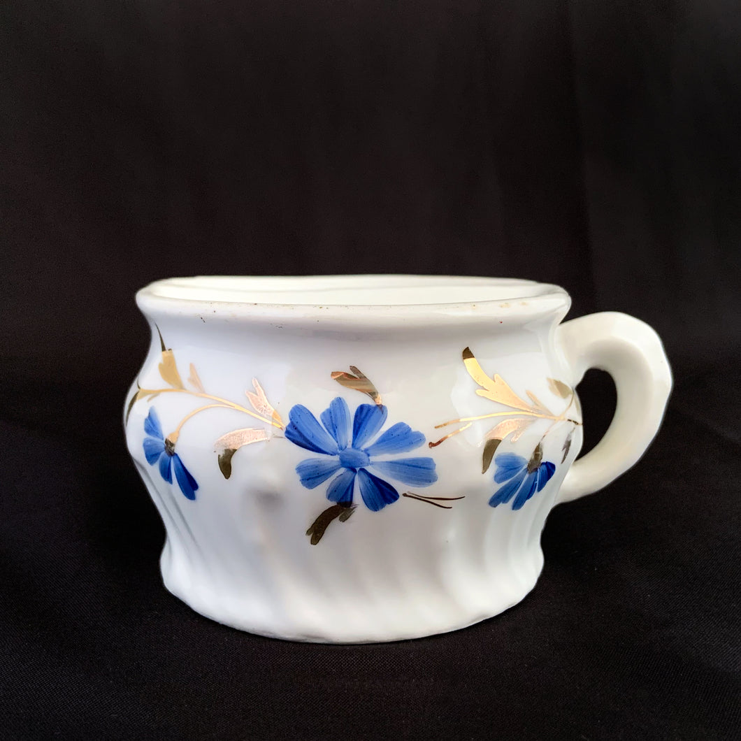 Vintage white porcelain shaving mug with blue flowers and gold leaves. Use as intended or repurpose as a toothbrush or make-up brush holder.  Unmarked.  In good vintage condition, no chips/cracks/repairs.  Dimensions: 3