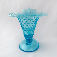 Load image into Gallery viewer, This gorgeous vintage blue hobnail cornucopia candle holder or vase has a lovely crimped opalescent edge. Produced by the Fenton Glass Co. in Williamstown, West Virginia, USA between 1940 - 1954 and 1959 - 1965.  It is perfect as a candle holder or flower vase or could even be used for make-up brushes on a vanity. The glass is a gorgeous light blue with milky opalescent rims that will brighten any room.   Unmarked and in excellent condition, no chips and no cracks.  Measures 5-1/4&quot; x 5&quot; x 5-1/2&quot; 
