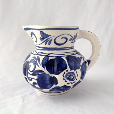 Lovely vintage hand painted pitcher with blue floral on a white ground. Perfect size to use as a large creamer or gravy pitcher. Italy.  In excellent condition, no chips or cracks. Marked on the bottom 