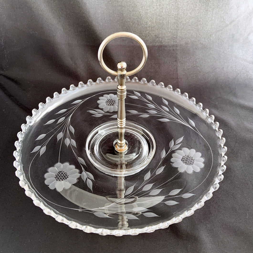 We're proud to offer this elegant Candlewick crystal tidbit serving tray with decorative silver toned metal handle and cut by WJ Hughes in his distinctive 12-petalled 