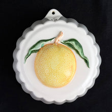 Load image into Gallery viewer, Vintage ceramic kitchen hanging round mold with an orange, circa 1970. Made by Crowning Touch, Japan.  In excellent condition, no chips or cracks.  Measures 5-1/2&quot;
