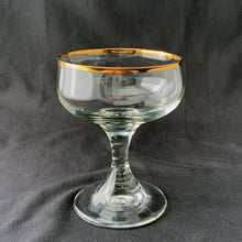 Load image into Gallery viewer, A stunning set of six elegant stemmed clear crystal champagne or sherbet glasses. Each bowl is rimmed and banded in 24 carat gold. Perfect for entertaining with a touch of elegance...cheers!  All are in excellent  condition with no scratches, chips, or cracks. Maker unknown.  Each glass measures 3 3/4 x 4 3/4 inches
