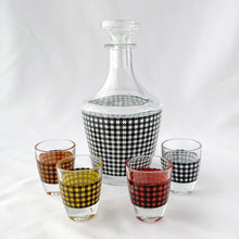 Load image into Gallery viewer, This mid-century vintage decanter and four shot glass set is so retro! The houndstooth pattern is vibrant and quite the conversation piece. What a fun set for a casual vintage vibe.  All pieces are in excellent condition, free from chips or cracks. Marked &quot;FRANCE&quot; on the bottom. Made by Cristal D&#39;arques in the 1950s.  The decanter measures 3 x 6 1/2 inches and the shot glasses 1 1/2 x 2 inches
