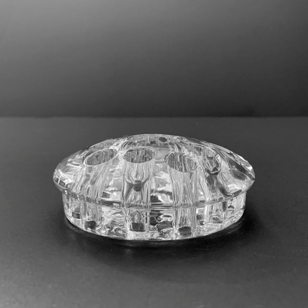 This clear glass narrow rimmed flower frog has 10 holes and a central space for a taper candle. This frog pairs with the #1007 flowerlite produced by the Viking Glass Company, 1952. It may be used with any vessel to create a beautiful floral arrangement.  In excellent condition, free from chips/cracks.  Measures 3 1/8 x 1 1/4 inches
