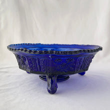 Load image into Gallery viewer, Gorgeous antique cobalt blue  &quot;Butterfly and Berries&quot; paneled bowl with three feet. Produced by the Fenton Art Glass, circa 1920s. The bowl panels have a lovely alternating pattern of raspberries on the vine and butterflies. The centre of the bowl has a butterfly surrounded by raspberries on the vine. A lovely decorative piece to use as a fruit bowl, catchall or decor piece.  In excellent condition, free from chips/cracks/wear.  Measures 9 1/4  x 3 3/4 inches
